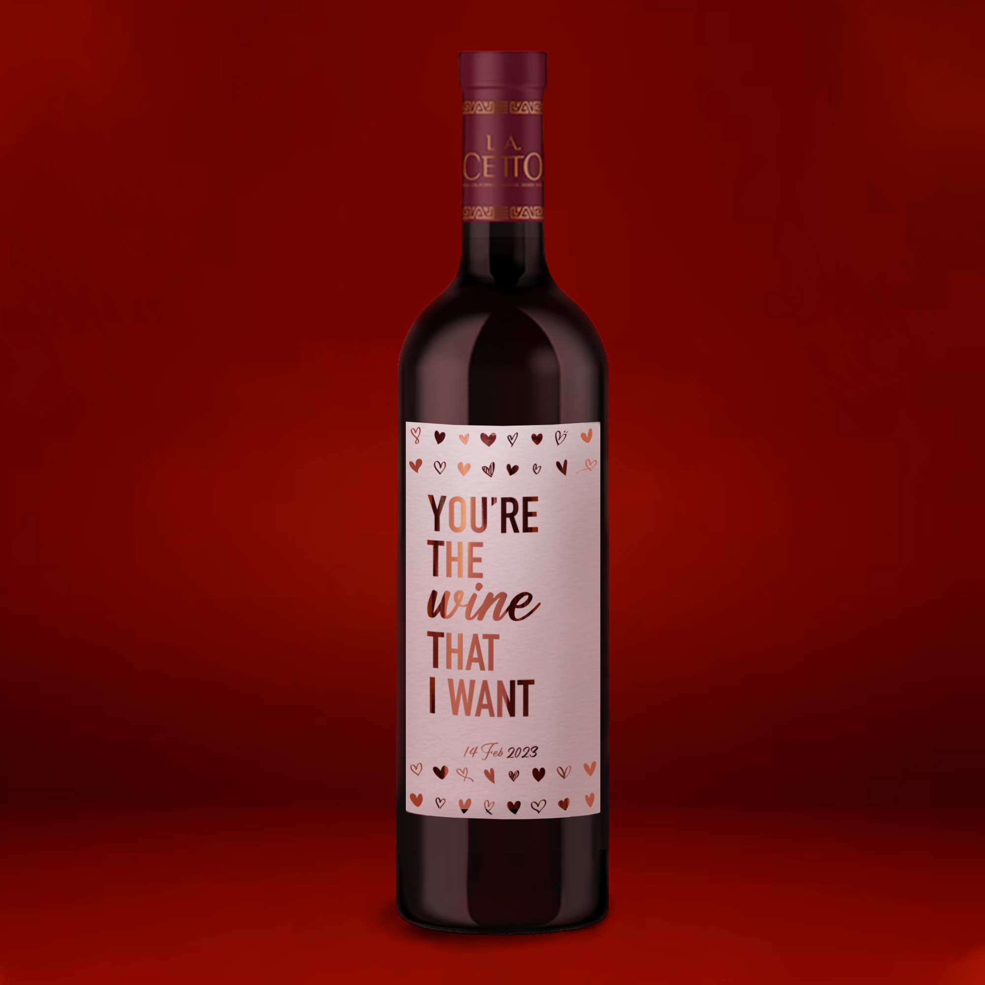 Botella de vino con etiqueta personalizada en foil rose gold tipo mensaje de San Valentín